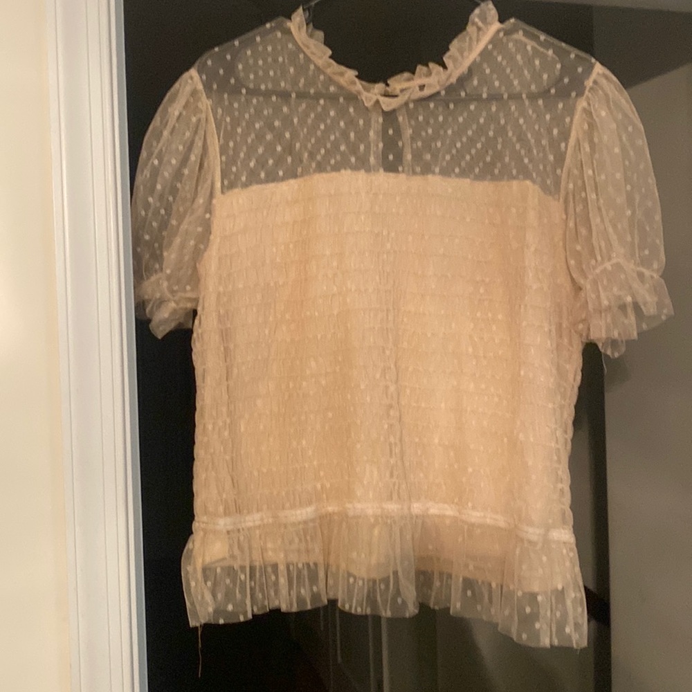 Women’s Lace top with ruffled neck.